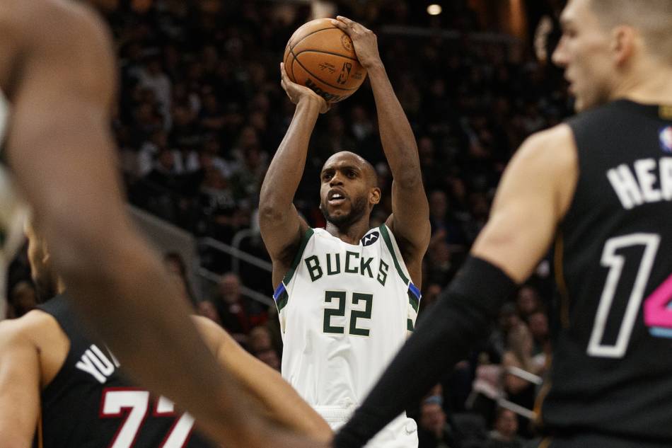 Milwaukee Bucks forward Khris Middleton (22) shoots the ball against the Miami Heat during the fourth quarter at Fiserv Forum. Jeff Hanisch, USA TODAY Sports/Reuters.