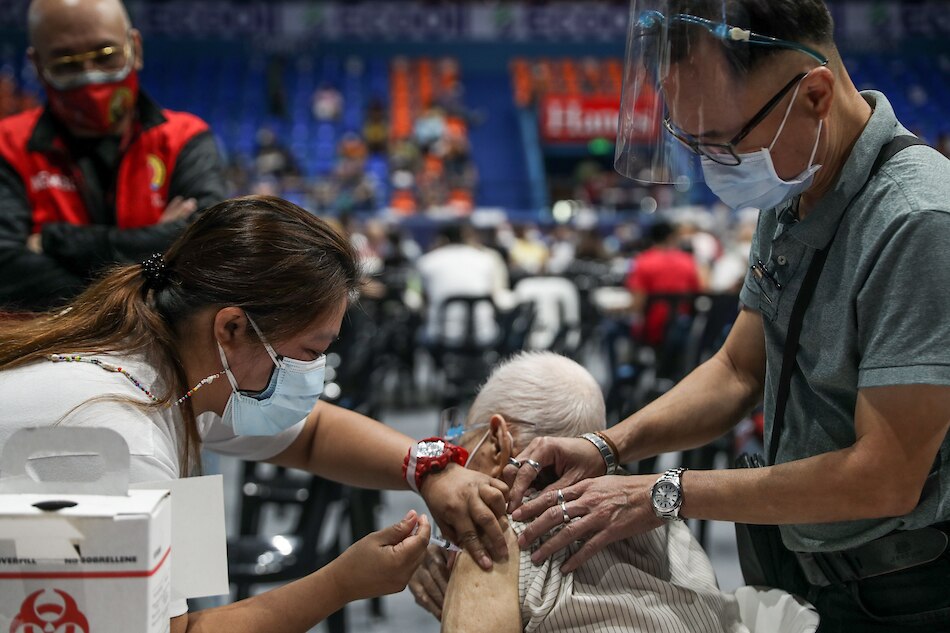 Senior citizens receive their Covid-19 vaccine booster shots at the Filoil San Juan Arena in San Juan City on Dec. 3, 2021. Jonathan Cellona, ABS-CBN News