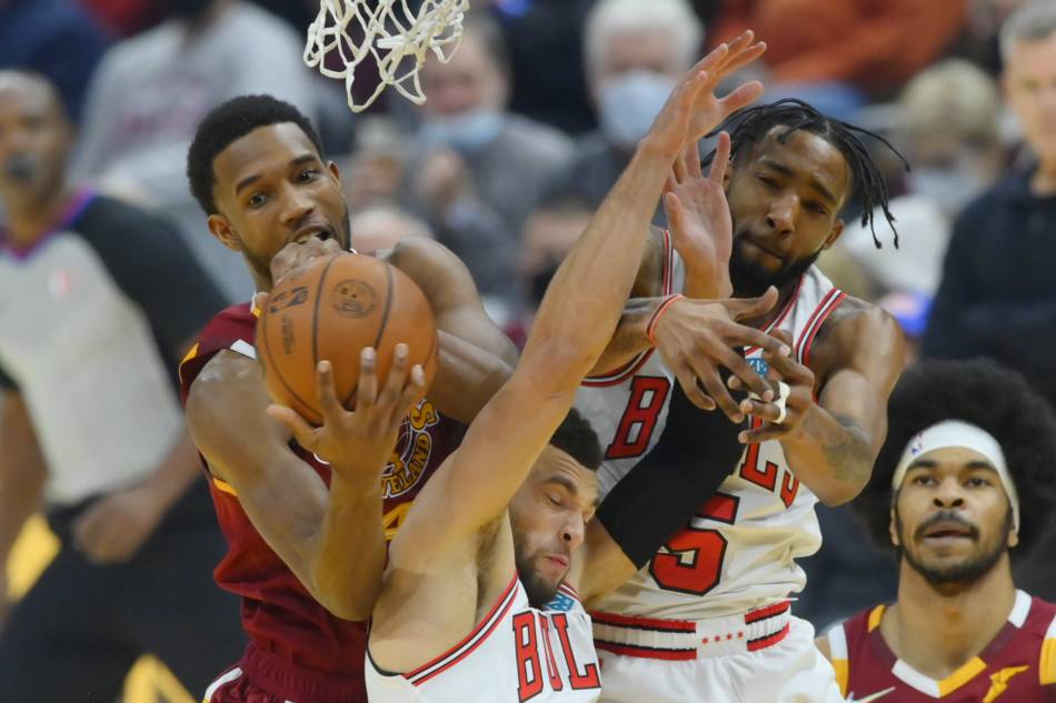 Cleveland Cavaliers center Evan Mobley (4) rebounds the ball behind Chicago Bulls guard Zach LaVine (8) and forward Derrick Jones Jr. (5) in the first quarter at Rocket Mortgage FieldHouse. David Richard, USA TODAY Sports/Reuters.
