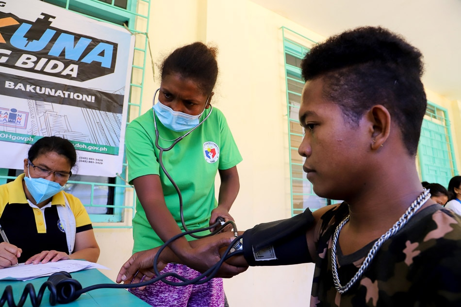 Barangay health worker Belinda S. Sulit checks the blood pressure of a resident at a tribal village in Kanaynayan, Castillejos, Zambales on December 14, 2021 during pre-screening for the COVID-19 vaccine. Jun Dumaguing, ABS-CBN News/File.