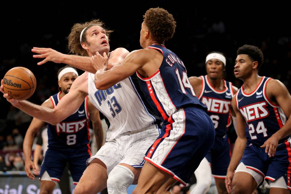 Orlando Magic center Robin Lopez (33) controls the ball against Brooklyn Nets forward Kessler Edwards (14) and guard Patty Mills (8) and guard David Duke Jr. (6) and guard Cam Thomas (24) during the fourth quarter at Barclays Center. Brad Penner, USA TODAY Sports/Reuters