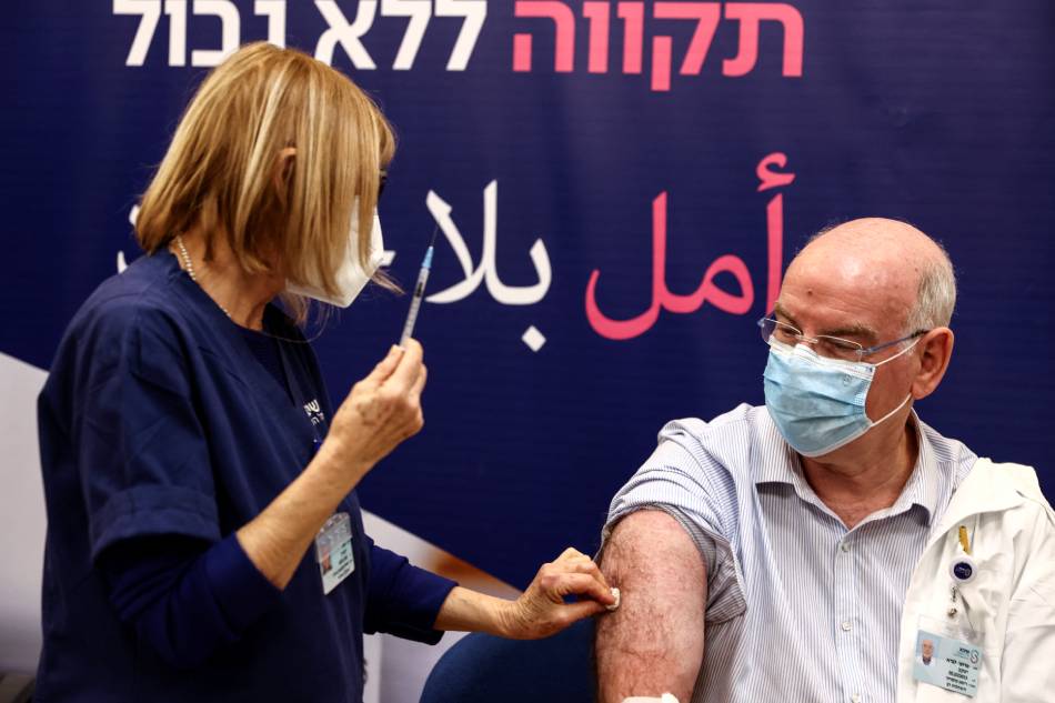 Professor Jacov Lavee receives a fourth dose of coronavirus disease (COVID-19) vaccine as part of a trial in Israel, as Health Ministry is considering offering the second booster to the elderly and immuno-compromised at Sheba Medical Center in Ramat Gan, Israel December 27, 2021. Ronen Zvulun, Reuters