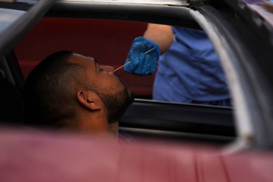 A man is tested for the coronavirus at a drive-through testing site as the omicron variant continues to spread through the country in Houston, Texas, US, Dec. 29, 2021. Callaghan O'Hare, Reuters