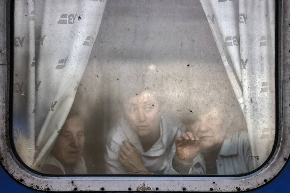 Women wave to bid farewell to relatives as they are about to leave by train at Slovyansk central station, in the Donbas region on April 12, 2022, amid the Russian invasion of Ukraine. The Ukrainian leaders of the Donetsk and Lugansk regions in the Donbas have asked civilians to evacuate west in reaction to an anticipated Russian offensive to take the eastern region. Ronaldo Schemidit, AFP