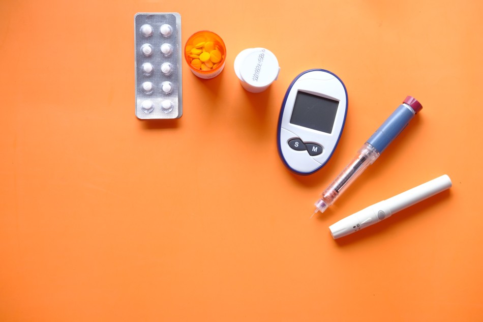 Pills, diabetic measurement tools, and Insulin pen. Photo source: Unsplash [LINK OUT 'Unsplash': https://unsplash.com/photos/ZJaK9jQXeDA