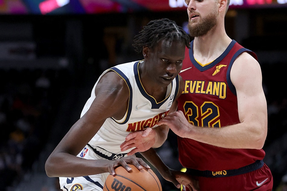 Nuggets center Bol Bol drives against Dean Wade of the Cavaliers in their game on October 25, 2021. Matthew Stockman, Getty Images/AFP/file
