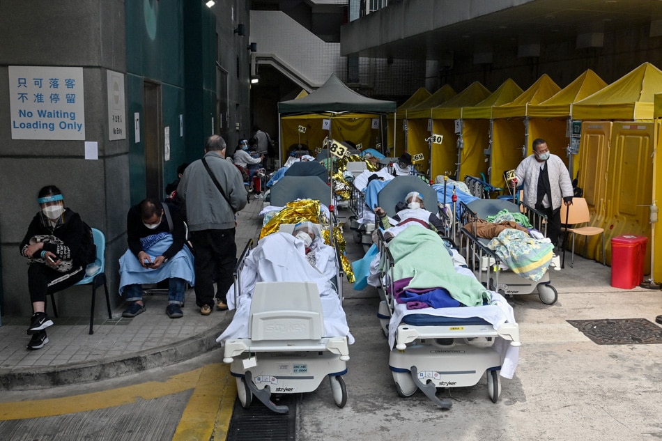 People lie on hospital beds outside Caritas Medical Center in Hong Kong on February 15, 2022, as the city faces its worst COVID-19 wave to date. Peter Parks, Agence France-Presse