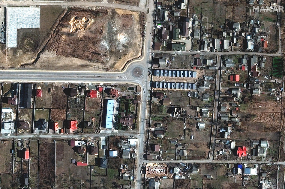 This handout satellite image released by Maxar Technologies on April 4, 2022 shows a view of Yablonska Street in Bucha, Ukraine, on March 18, 2022. Satellite photographs released on Monday appear to rebut Russian assertions that dead bodies in civilian clothing found in Bucha had appeared there after Russian forces retreated from the devastated Ukrainian town. Satellite image ©2022 Maxar Technologies / AFP