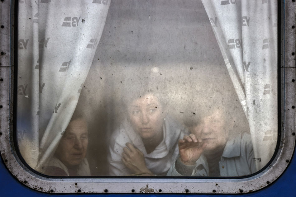 Women wave to bid farewell to relatives as they are about to leave by train at Slovyansk central station, in the Donbass region on April 12, 2022, amid the Russian invasion of Ukraine. The Ukrainian leaders of the Donetsk and Lugansk regions in the Donbas have asked civilians to evacuate west in reaction to an anticipated Russian offensive to take the eastern region. Ronaldo Schemidit, AFP