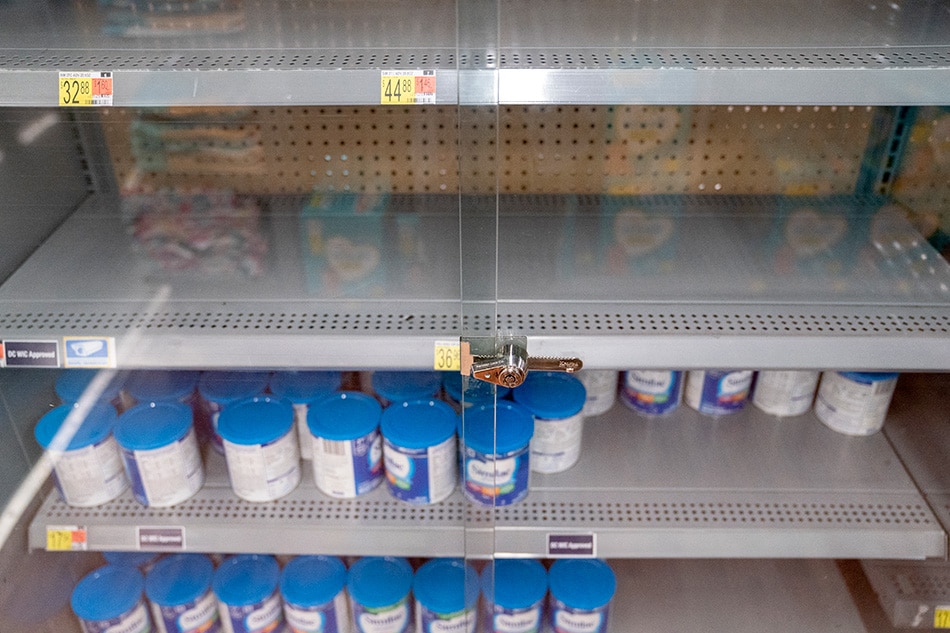 Grocery store shelves where baby formula is typically stocked are locked and nearly empty in Washington, DC, on May 11, 2022. The United States is in the grip of a severe shortage of baby formula -- with a mass product recall aggravating pandemic supply chain woes -- sending families on sometimes desperate hunts for the vital supplies. Stefani Reynolds / AFP