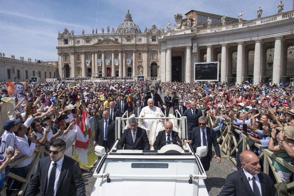 Pope Francis blesses attendees from the popemobile after a canonization Mass at St. Peter's Square in The Vatican in this photo released by The Vatican Media. Pope canonized 10 saints including India's Devasahayam, French hermit Charles de Foucauld and Dutch theologian Titus Brandsma. Vatican Media, AFP