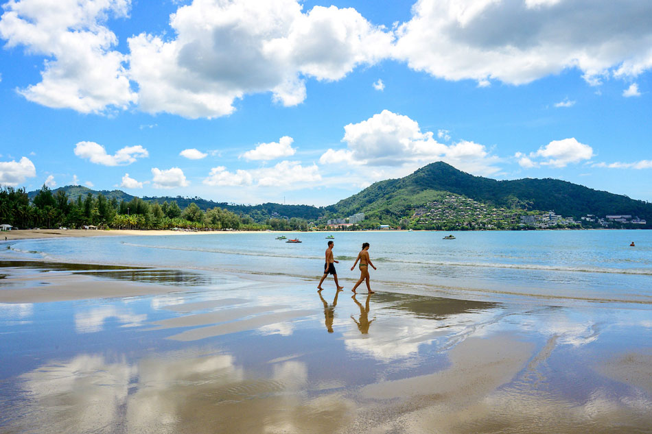 Tourists walk on a beach on the Thai island of Phuket on Nov. 1, 2021, as Thailand welcomes the first group of tourists fully vaccinated against COVID-19 without quarantine. Mladen Antonov, AFP