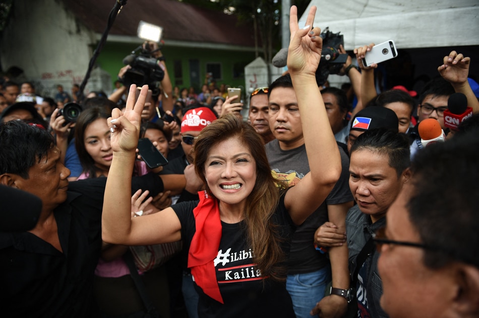 Imee Marcos, daughter of the late strongman Ferdinand Marcos, flashes the 'V' sign as she celebrates with supporters during a rally in front of the Supreme Court in Manila on November 8, 2016, after hearing the news of the high court's decision allowing the burial of her late father at the heroes' cemetery. Ted Aljibe, AFP