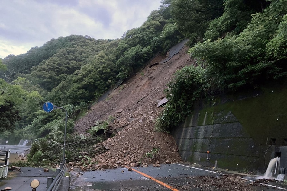 This handout picture taken and released on July 5, 2022 by the Tosa National Highway Office shows a landslide blocking a road in Nakatosa Town, Kochi Prefecture, following heavy rain. AFP/Tosa National Highway Office/handout 