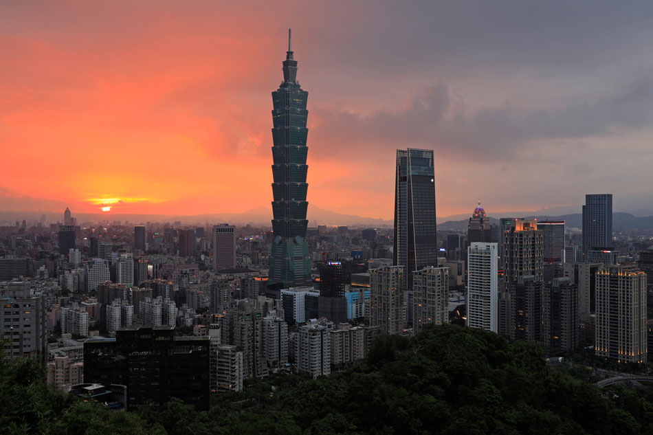 This picture taken on July 22, 2018 shows a view of the Xinyi Shopping District, including the Taipei 101 building at sunset in Taipei. Daniel Shih, AFP/File