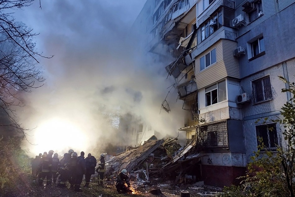 Rescuers gather outside a residential building damaged after a strike in Zaporizhzhia, amid the Russian invasion of Ukraine. Maryna Moiseyenko, AFP/File