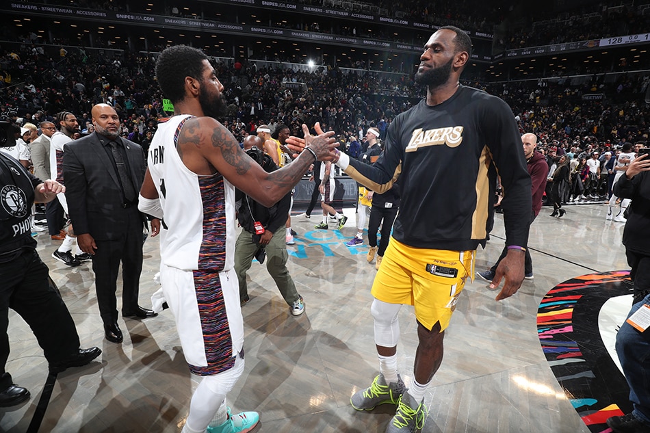 Kyrie Irving and LeBron James hi-five after a game on January 23, 2020 in Brooklyn, New York. Nathaniel S. Butler, NBAE via Getty Images/AFP/file