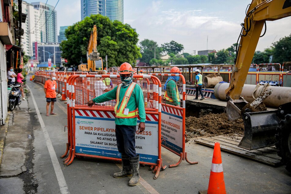 Construction workers dump soil on a large sinkhole at a portion of Coronado St. in Mandaluyong on November 26, 2021. George Calvelo, ABS-CBN News