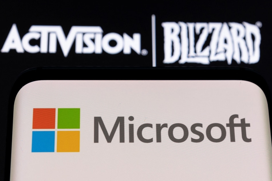 Microsoft logo is seen on a smartphone placed on displayed Activision Blizzard logo in this illustration taken January 18, 2022. Dado Ruvic, Reuters illustration