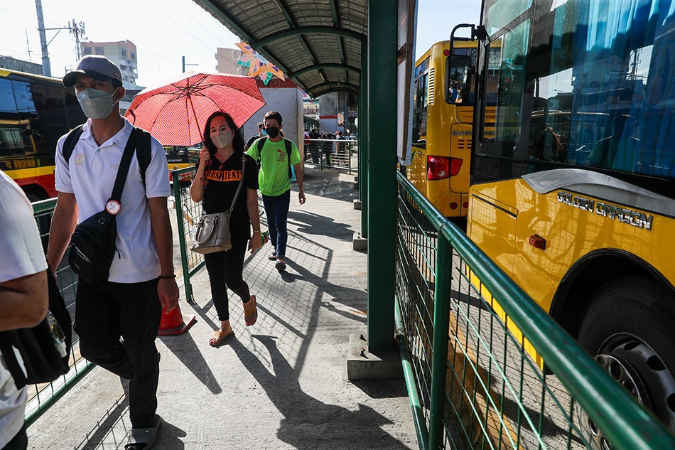 People wearing face masks as a precaution against COVID-19 fall in line at the Monumento bus stop in Caloocan on January 3, 2021. Jonathan Cellona, ABS-CBN New/File