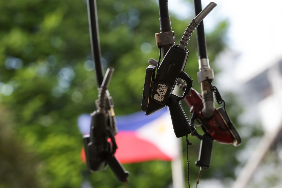 Fuel nozzles hang at a gasoline station in Manila on February 26, 2022. Gasoline prices which already increased for 8 straight weeks recently are expected to rise further amid the escalating conflict between Ukraine and Russia. George Calvelo, ABS-CBN News