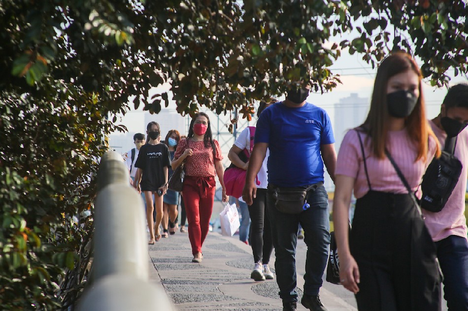 People walk in the business district of Makati City on March 3, 2022 as the Philippines eases quarantine rules, with many workers returning to work. Jonathan Cellona, ABS-CBN News/file