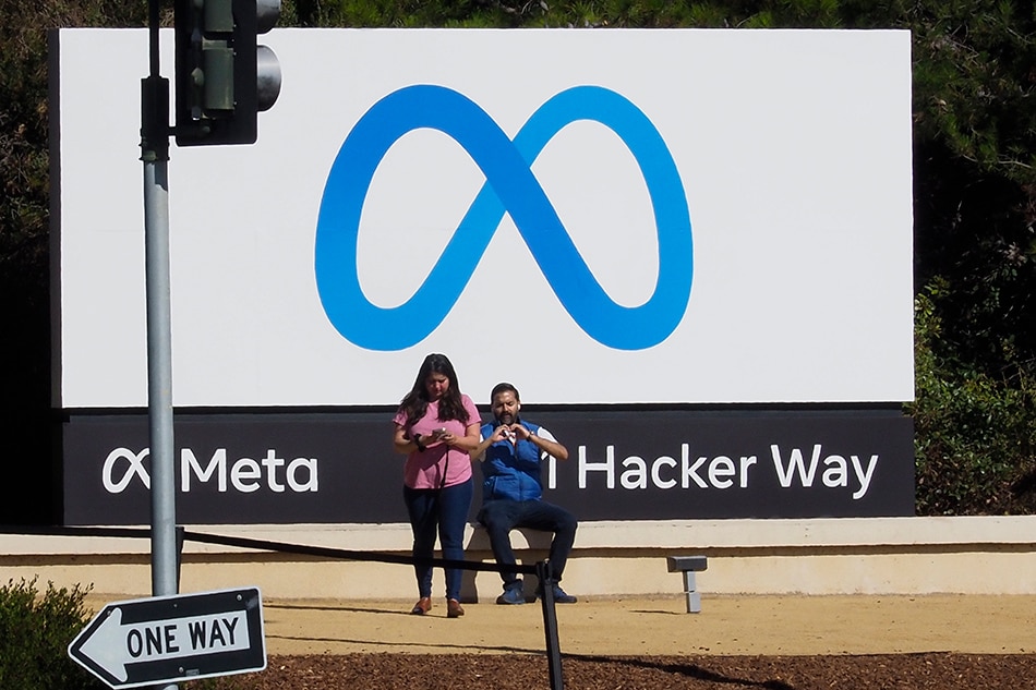 Visitors take picture of billboard sign featuring a new logo and name 'Meta' in front of Facebook headquarters in Menlo Park, California, USA, 29 October 2021. John Mabanglo, EPA-EFE