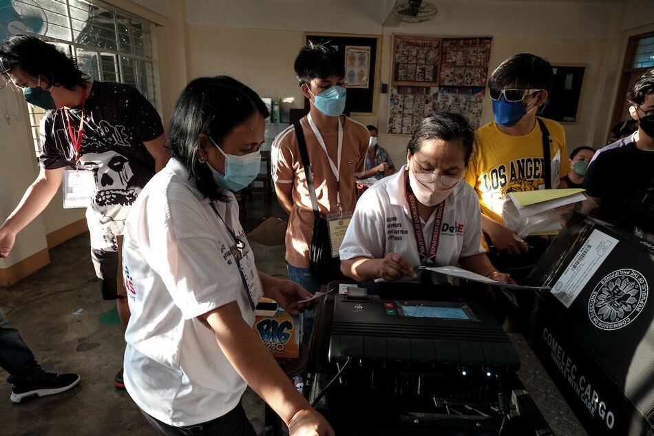 Electoral board officers at Precint 1055 at the Tomas Morato Elementary Sschool in Quezon City do the initial setup and checking to start the operation of the Vote Counting Machine during the national elections on May 9, 2022. Fernando G. Sepe Jr., ABS-CBN News