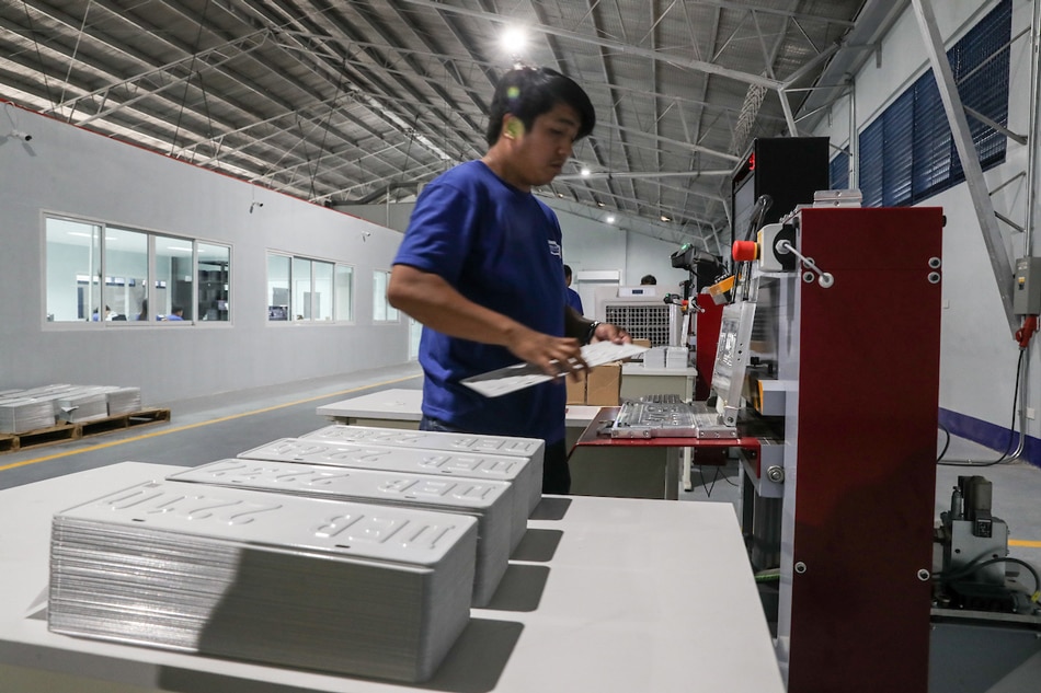 A staff worker operates a hot-foil printing machine as they produce plate numbers at the Land Transportation Office (LTO) plate-making plant/assembly line in its headquarters in Quezon City. Jonathan Cellona, ABS-CBN News 