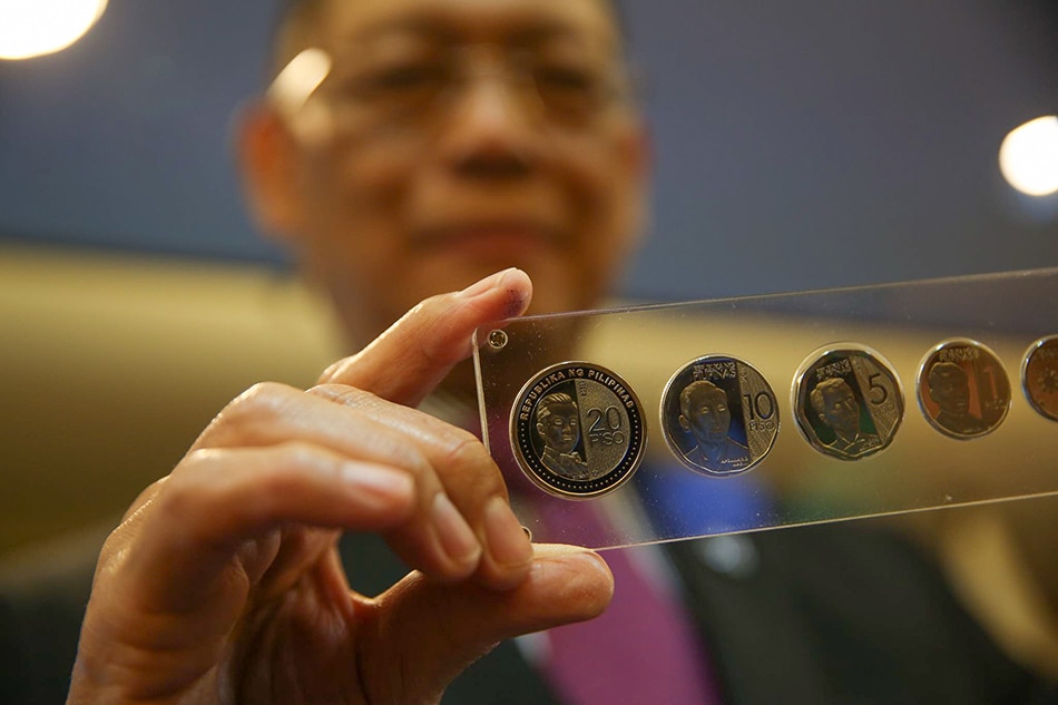 Central Bank Governor Benjamin Diokno holds newly minted set of 20-peso and Enhanced 5-peso NGC coins at the Executive Business Center at the Bangko Sentral ng Pilipinas, (BSP) in Manila on Dec. 17, 2019. Jonathan Cellona, ABS-CBN News/File