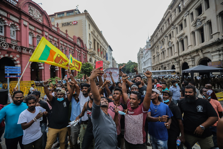 Protesters shout slogans and wave Sri Lankan flags during a protest near the Presidential House in Colombo, Sri Lanka, 24 May 2022. Chamila Karunarathne, EPA-EFE