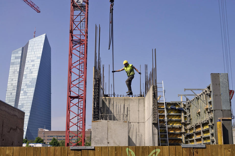 A workers seen at a construction site of an apartment building with the European Central Bank, ECB, on the background left, Frankfurt am Main, Germany, May 4, 2018. Mauritz Antin, EPA-EFE/File 