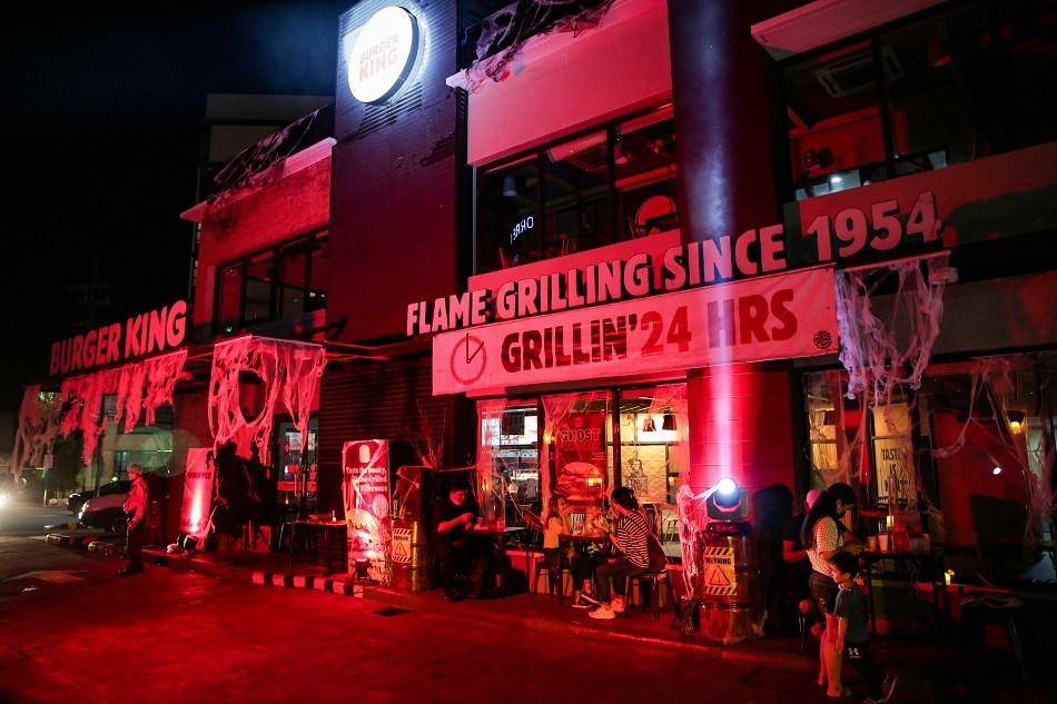 People visit Burger King's Halloween-themed branch in Quezon City on October 29, 2021. George Calvelo, ABS-CBN News/file