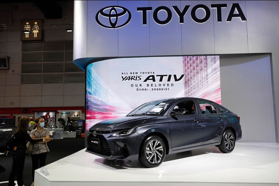 Visitors inspect a Toyota Yaris Ativ car displayed at the Big Motor Sale 2022 event in Bangkok, Thailand, Aug. 25, 2022. Rungroj Yongrit, EPA-EFE/File 