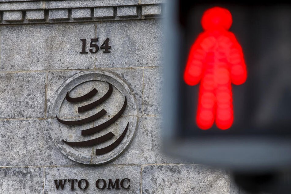 The WTO logo is pictured against a traffic light standing in front of the WTO headquarters in Geneva, Switzerland, 09 December 2019. EPA-EFE/SALVATORE DI NOLFI
