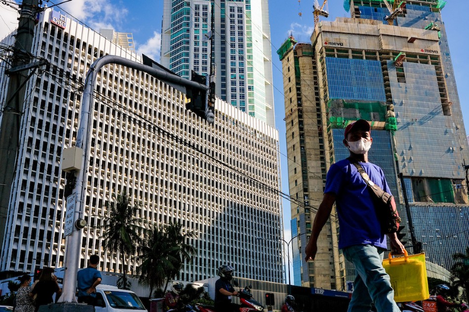 Pedestrians cross an intersection in the Makati Business District on October 6, 2022. George Calvelo, ABS-CBN News/File