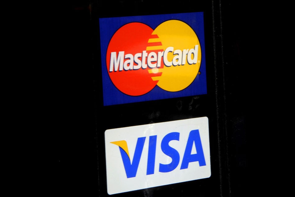 The Visa and Mastercard logo are displayed in store fronts in New York City, New York, USA, 30 March, 2012. EPA/PETER FOLEY EPA/PETER FOLEY/FILE