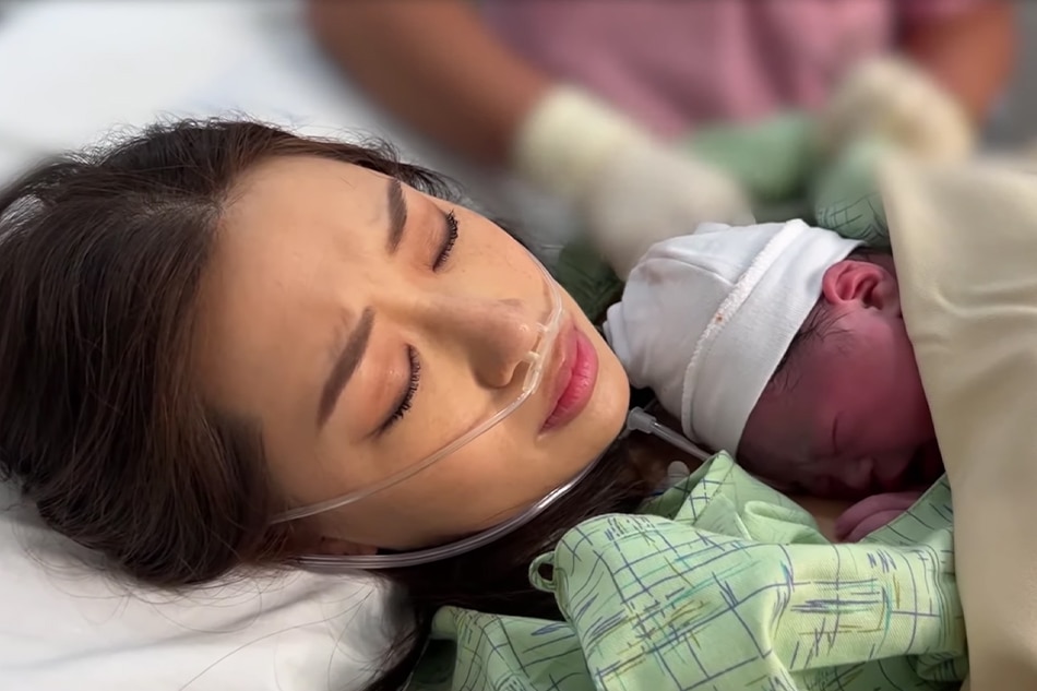 Kryz Uy hold her second child shortly after giving birth, as seen in her May 25 vlog. YouTube: Kryzzzie