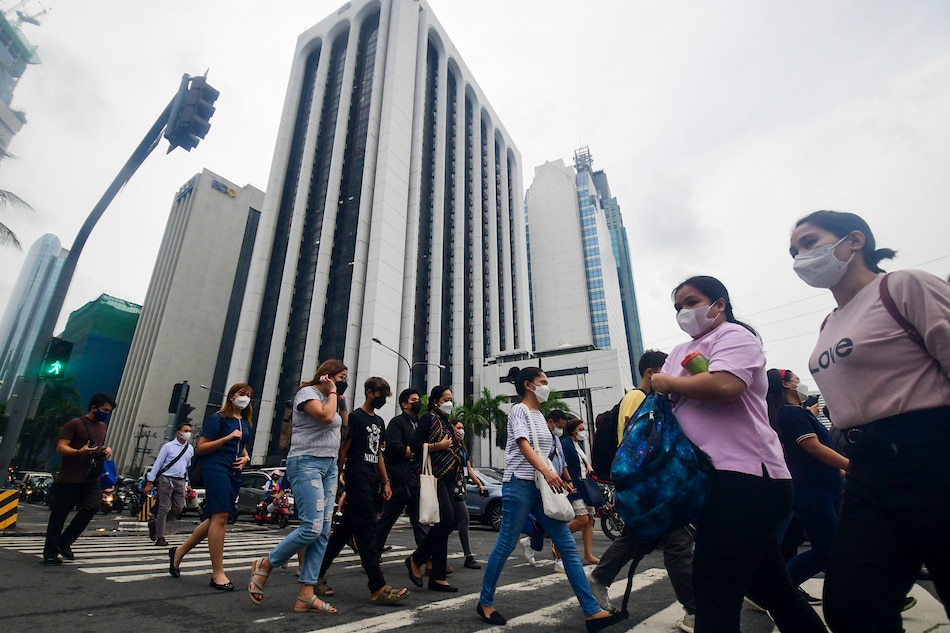 Pedestrians walk at a crossing in Makati City on July 12, 2022. Mark Demayo, ABS-CBN News