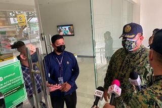 Quezon City cops inspect quarantine hotels