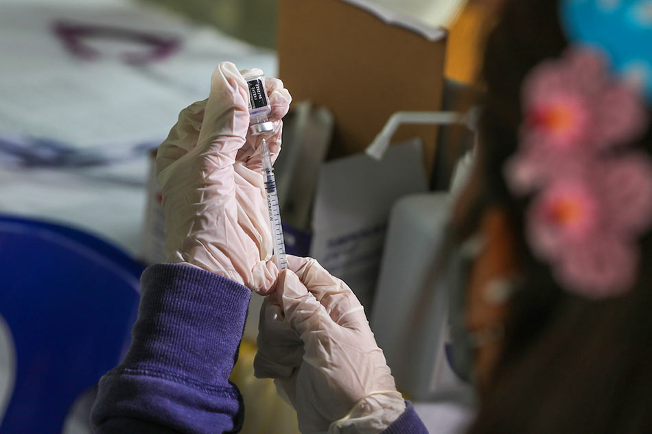 A health worker prepares a shot of COVID-19 vaccine during the pediatric vaccination drive at the Manila Zoo on February 7, 2022.