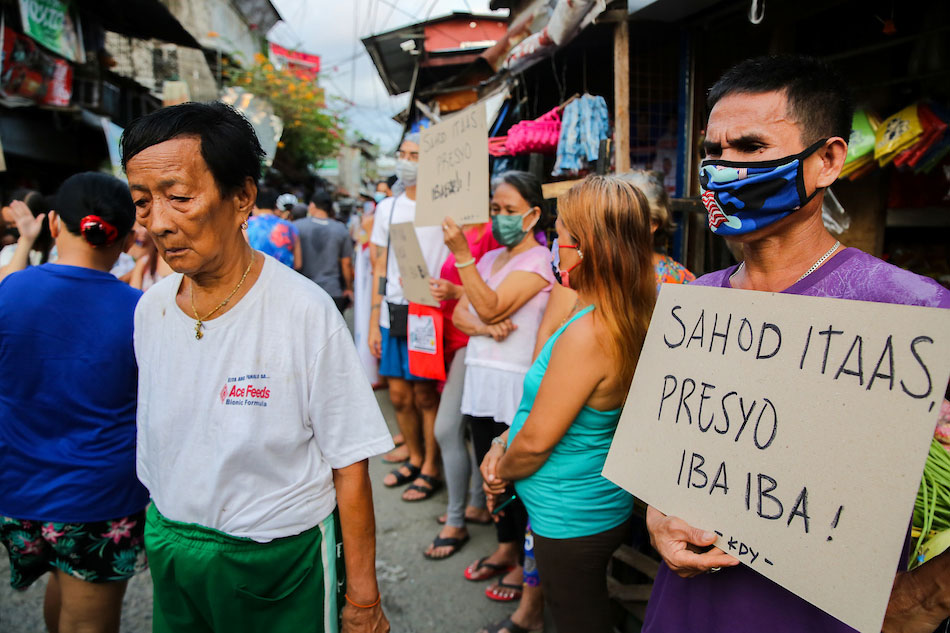  Members of the urban poor group Kalipunan ng Damayang Mahihirap (Kadamay) hold a protest at the San Roque Public Market in Quezon City on March 04, 2022, to call on the government to impose price control on goods and raise wages for workers. Jonathan Cellona, ABS-CBN News