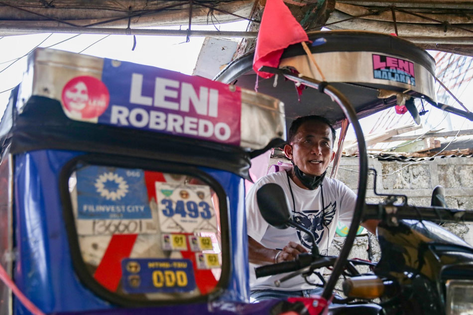 Ronald Carigo rides his tricycle decorated with tarpaulins of Robredo and her slate. Geroge Calvelo, ABS-CBN News