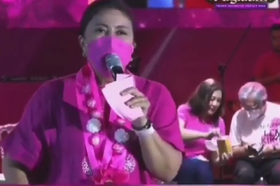 Actress Sharon Cuneta, holding a bottle of medicine, and former Negros Occidental governor Rafael Coscolluela are absorbed in conversation in the middle of Robredo's speech at a campaign rally in Bacolod city on March 11. Screengrab from Sharon Cuneta/Instagram