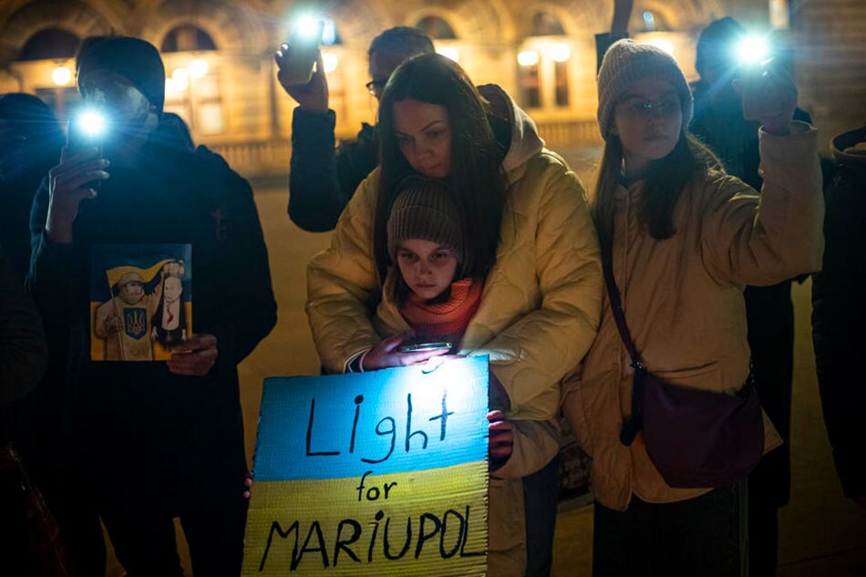 People take part in the Light for Mariupol peace rally EPA-EFE/file