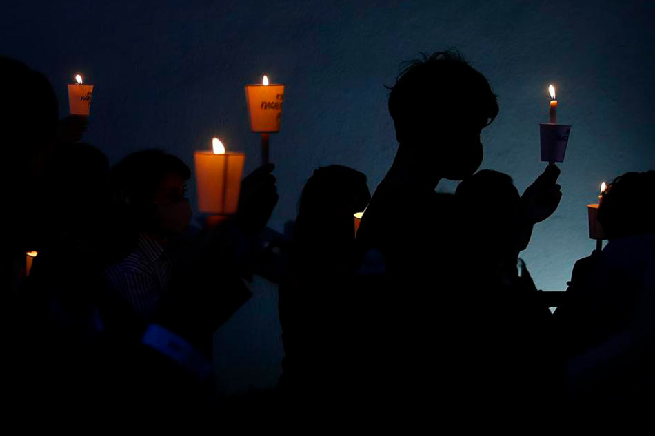 Activists hold candles during a candlelight vigil against the impending execution of Nagaenthran K Dharmalingam, who was convicted of a drug offense 10 years ago in Singapore but diagnosed as intellectually disabled, outside the Singaporean embassy in Kuala Lumpur, Malaysia, Nov. 8, 2021. Fazry Ismail, EPA-EFE/File