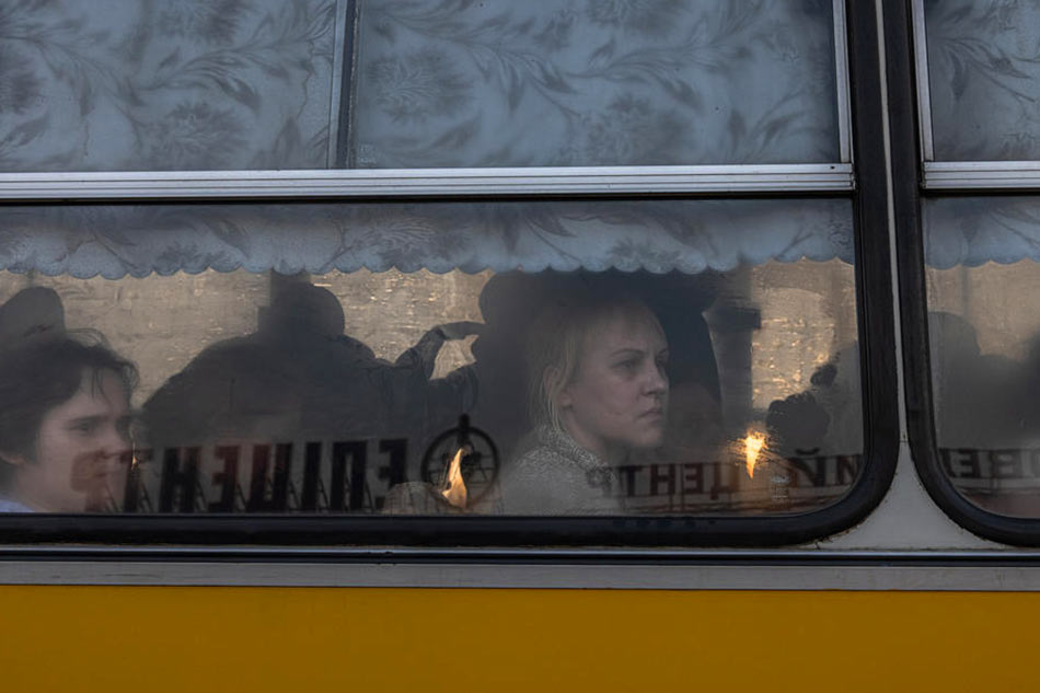 Evacuees sit on a bus EPA-EFE