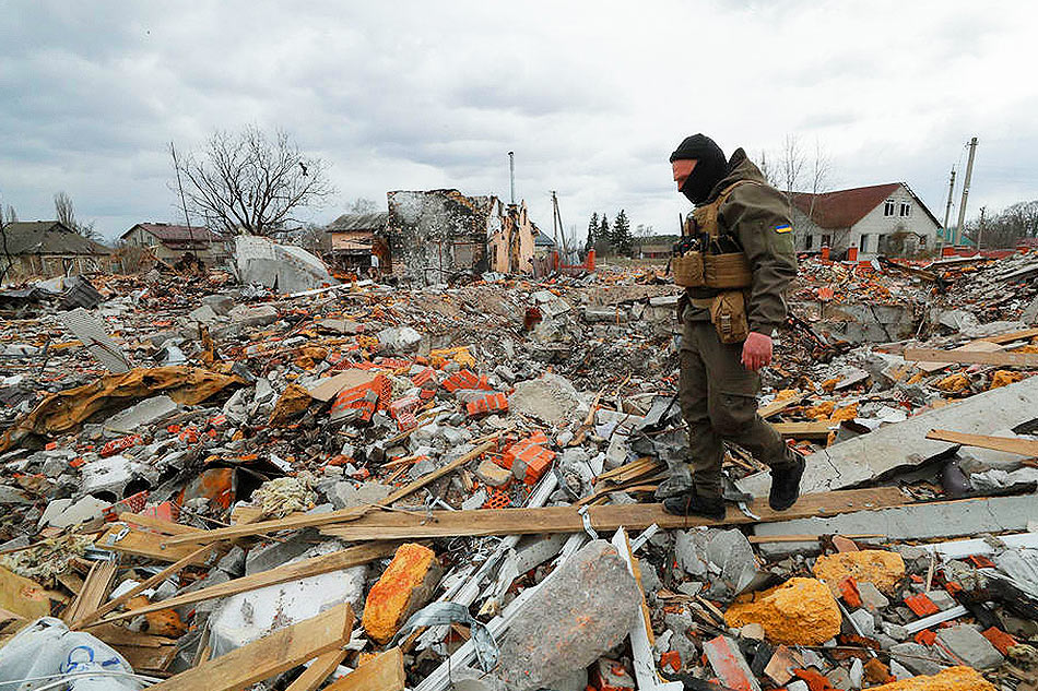 Ukrainian servicemen review the debris of damaged buildings to find explosive ammunition and mines in Bohdanivka village not far from Brovary, Kyiv area, in Ukraine, on April 12, 2022. Sergey Dolzhenko, EPA-EFE/file