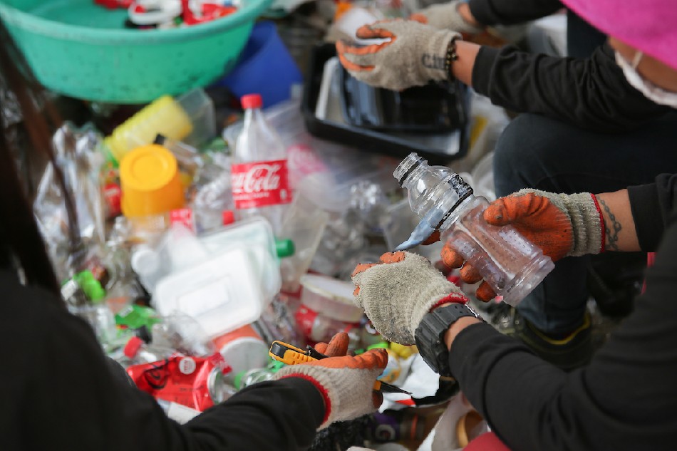 Workers sort different types of plastic at The Plastic Flamingo upcycling facility in Muntinlupa City on March 18, 2022. George Calvelo, ABS-CBN News