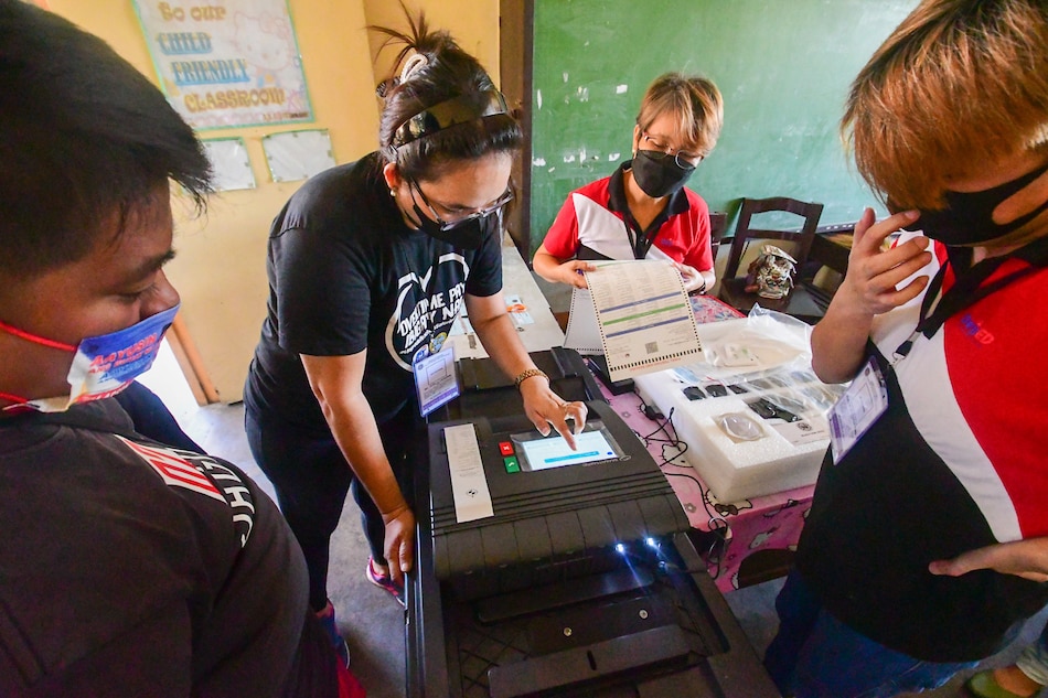 Members of the Electoral Board and poll watchers conduct their final testing and sealing of vote counting machines at Melencio M. Castelo Elementary School in Quezon City on May 3, 2022, five days before the national elections. Mark Demayo, ABS-CBN News
